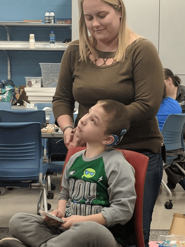 Deaf-blind student and his teacher in the classroom