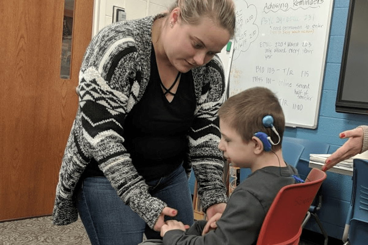 Teacher working with her deaf-blind student