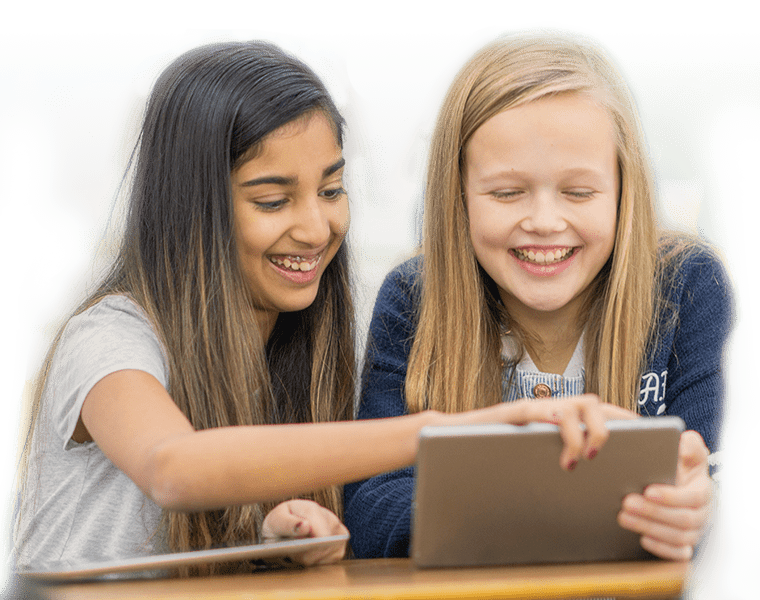 Two girls looking at a tablet in class