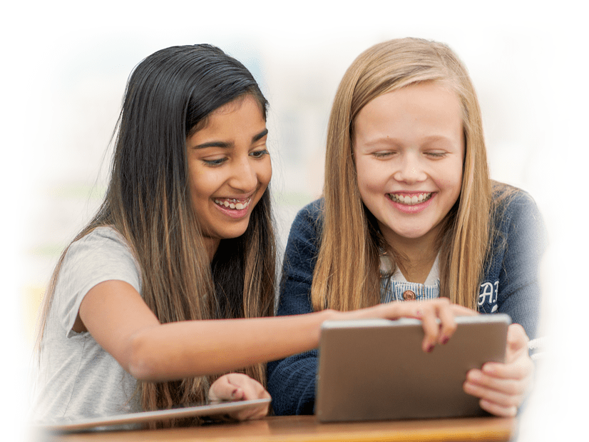 Two girls working on tablets