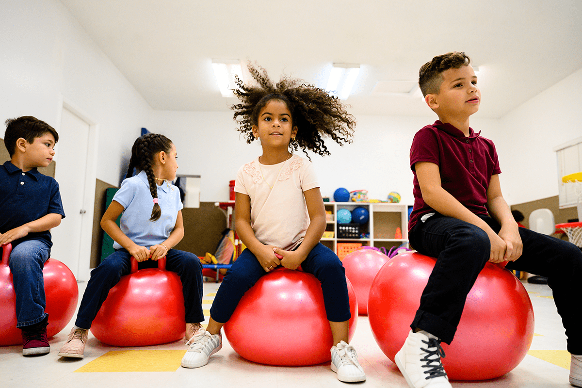 children bouncing on exercise balls