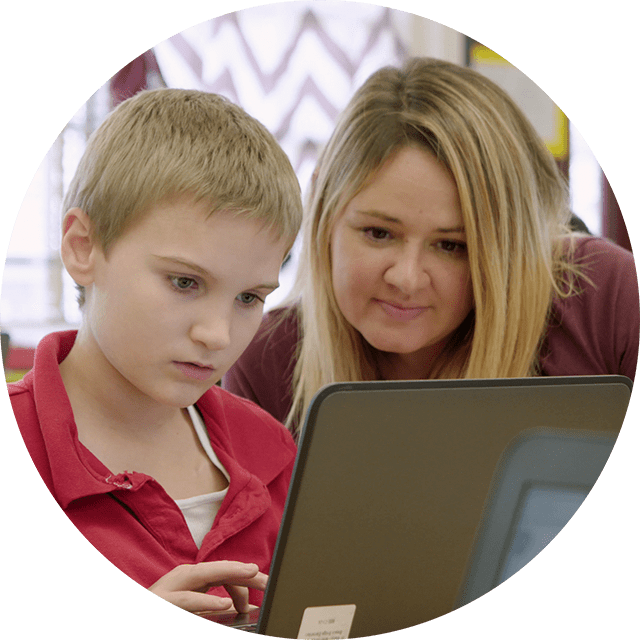 Student and teacher working on laptop