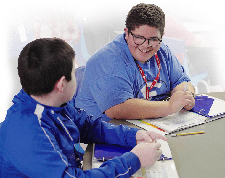 Two students interacting in class. 