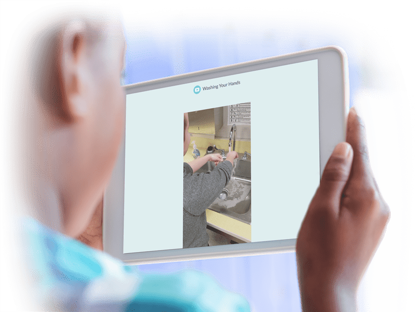 Boy on a tablet looking at Positivity Video Modeling