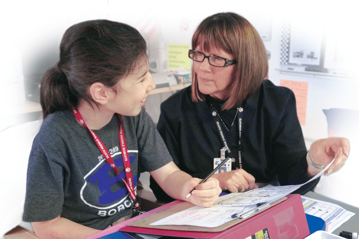 Student and teacher working together.
