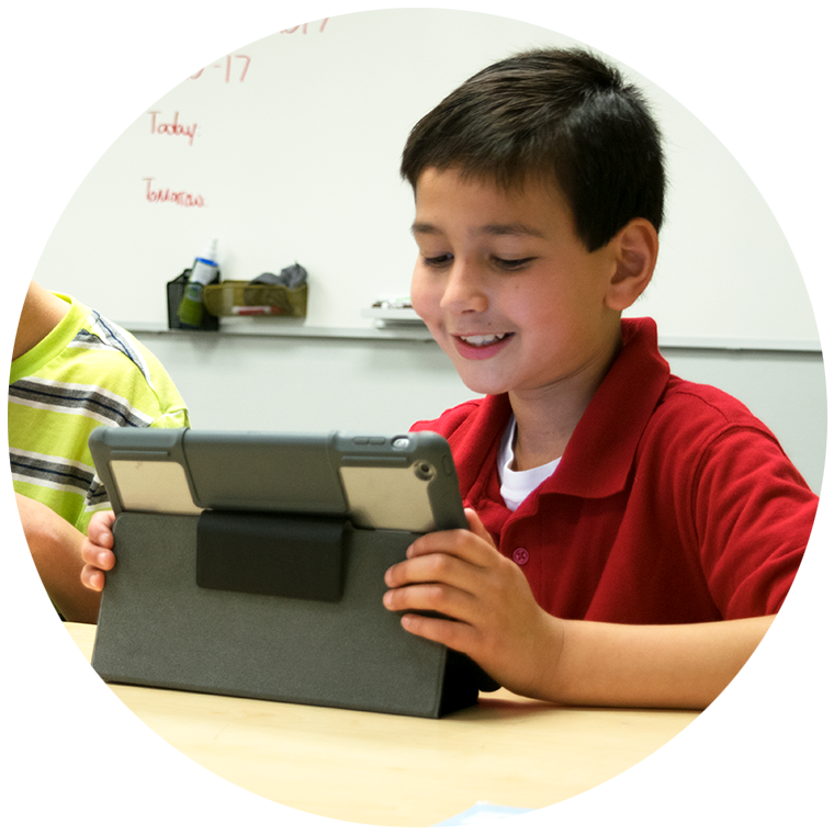 Middle school student using a tablet in class