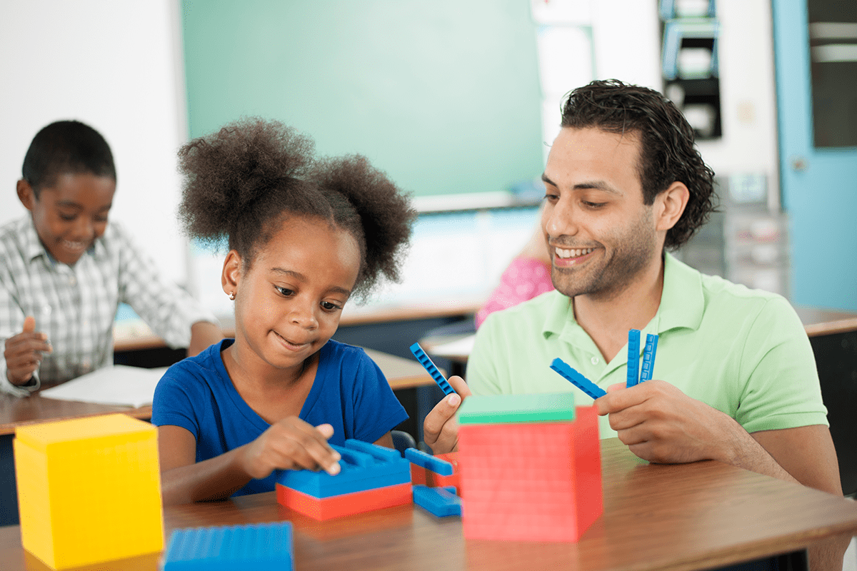 child and teacher using blocks as manipulatives