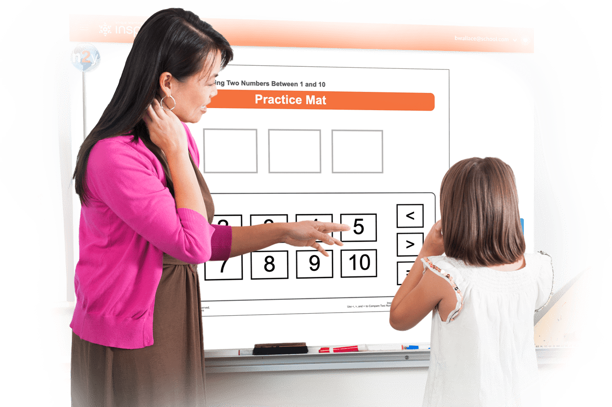 Teacher and student at interactive whiteboard helping student with Math Courses lesson.