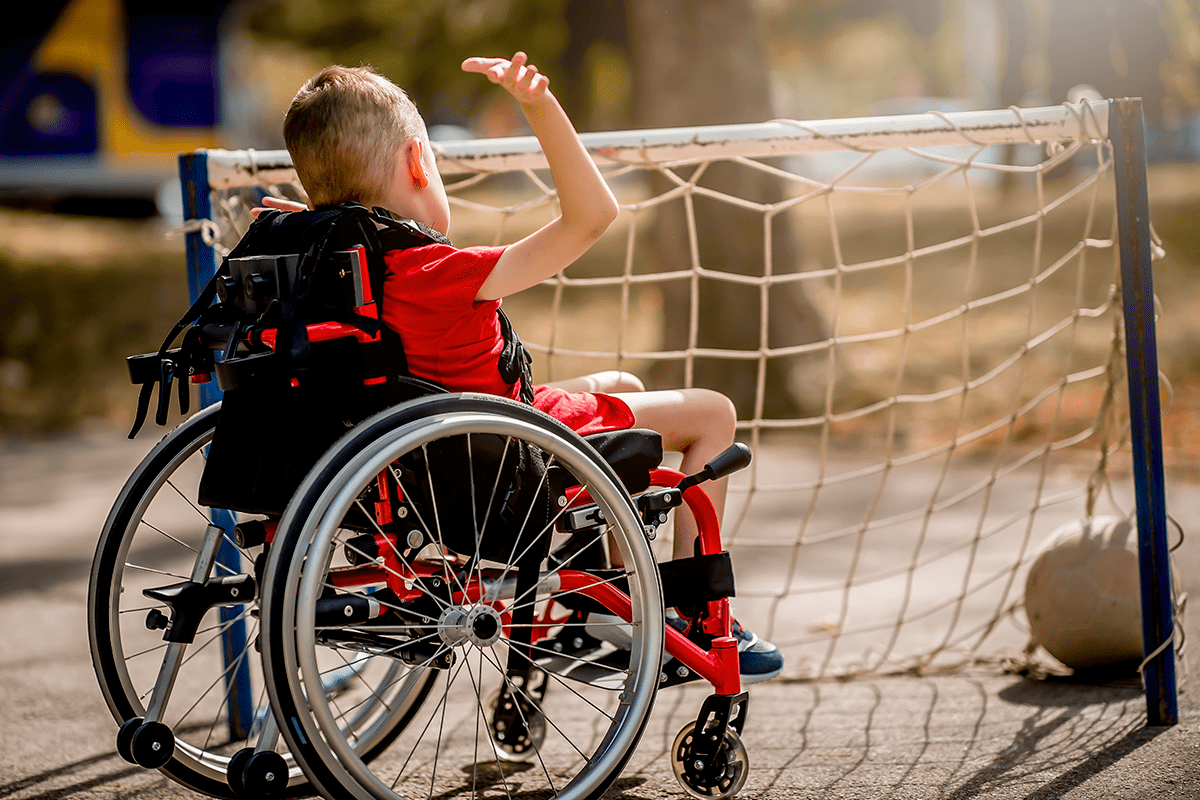 boy in wheelchair playing soccer